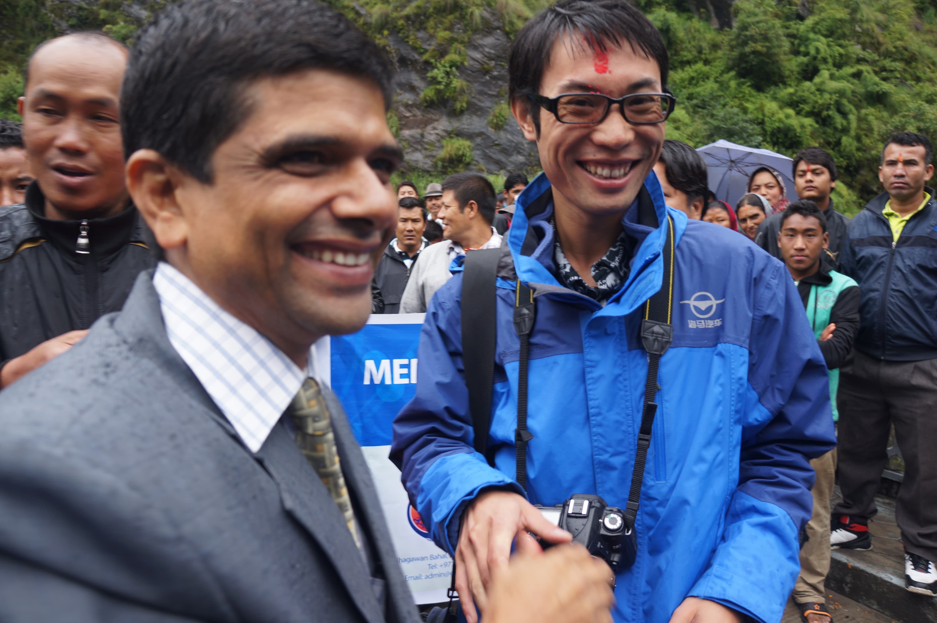 Travel partners and local hosts meeting outdoors during a mountain visit